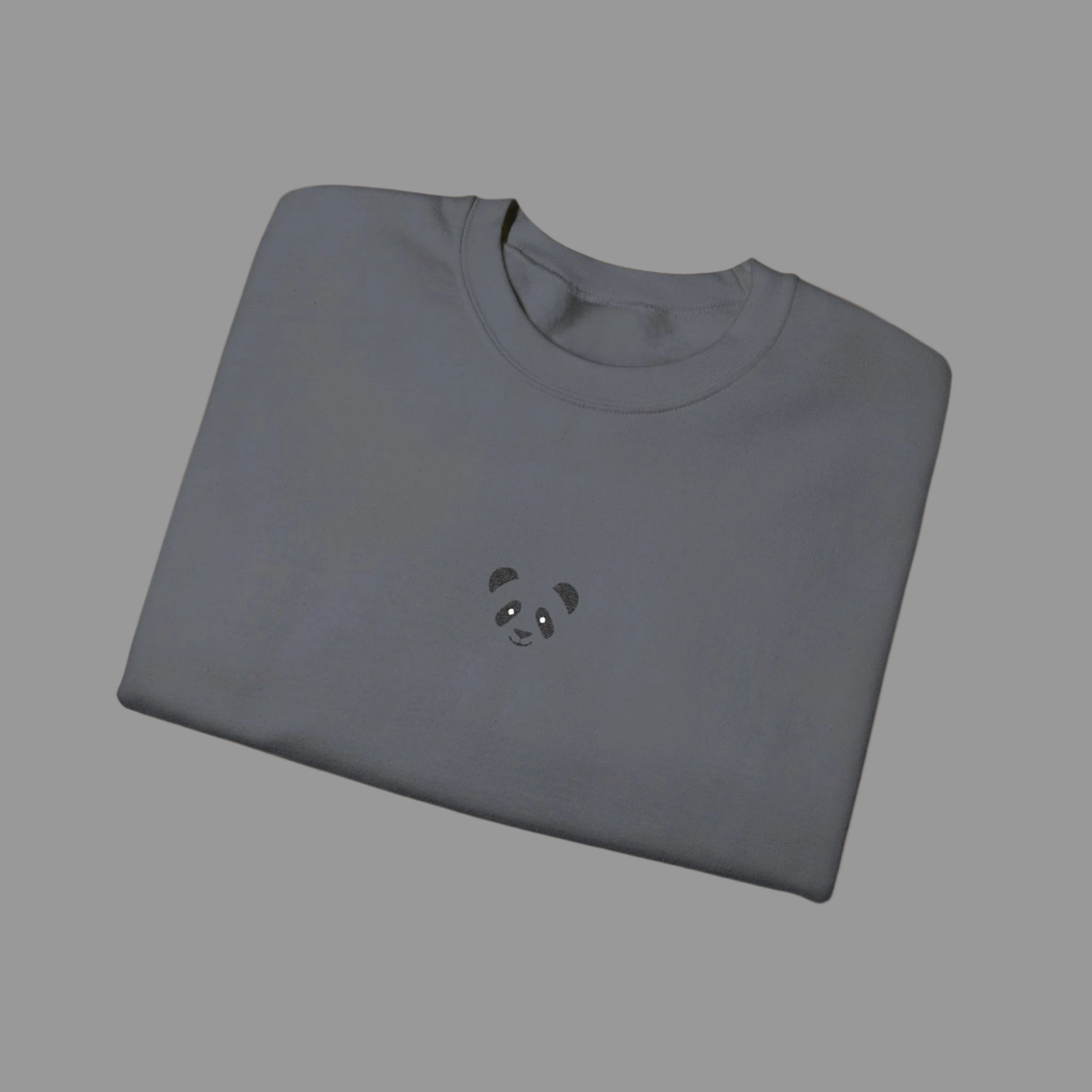 Folded gray sweatshirt with a panda design on a white background