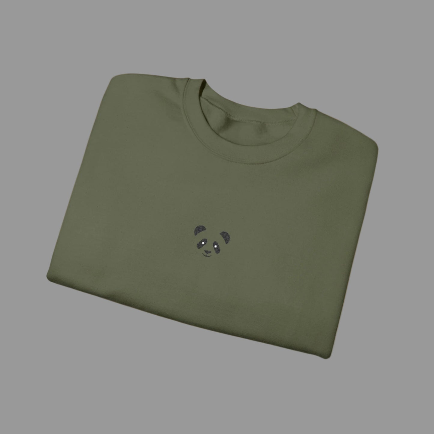 Folded green sweatshirt with a small panda design on a white background