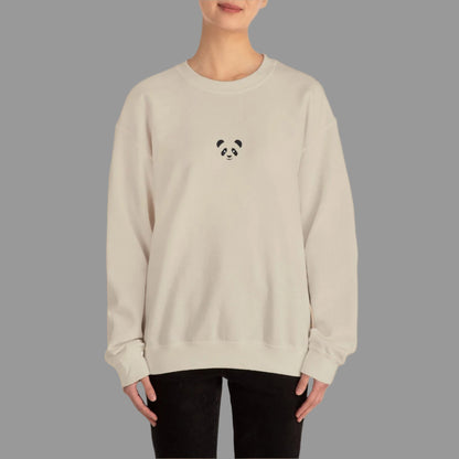 Person wearing a beige sweatshirt with a panda design on a white background