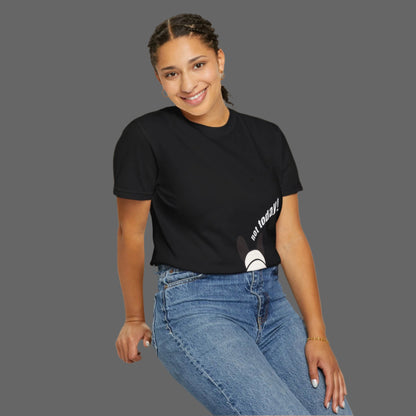 Person wearing a black t-shirt with text and blue jeans on a white background