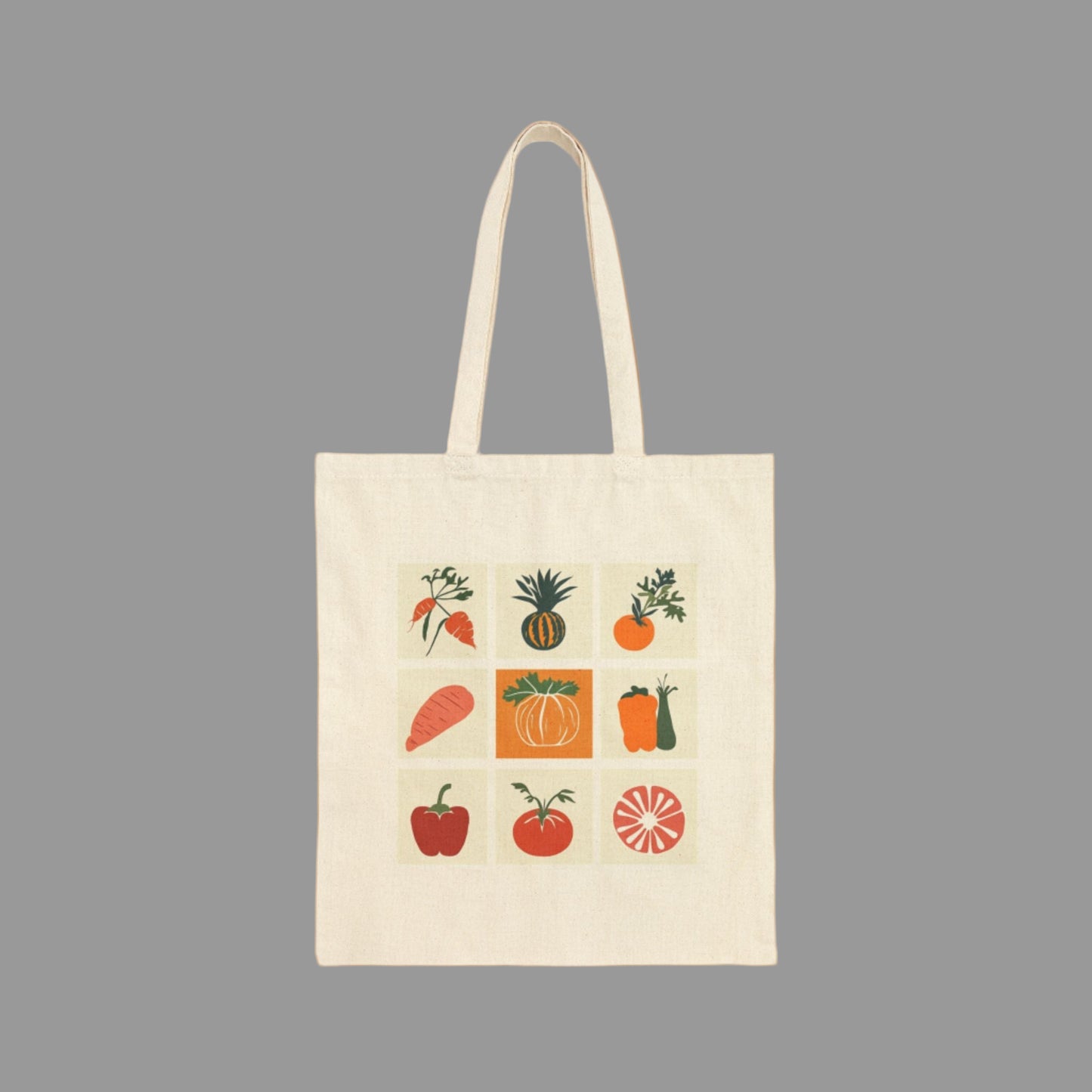 Beige tote bag with colorful fruit and vegetable illustrations on a white background