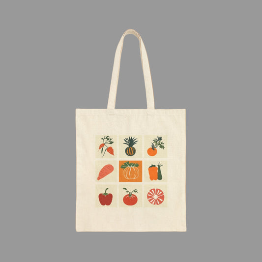 Beige tote bag with colorful fruit and vegetable illustrations on a white background