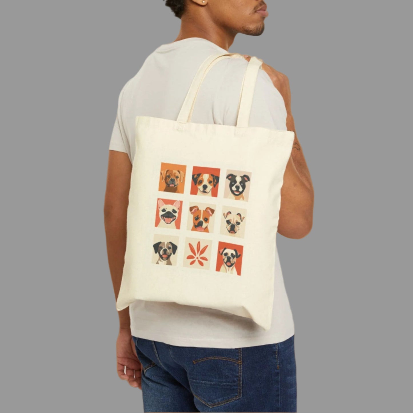 Man carrying a tote bag with dog illustrations on a white background
