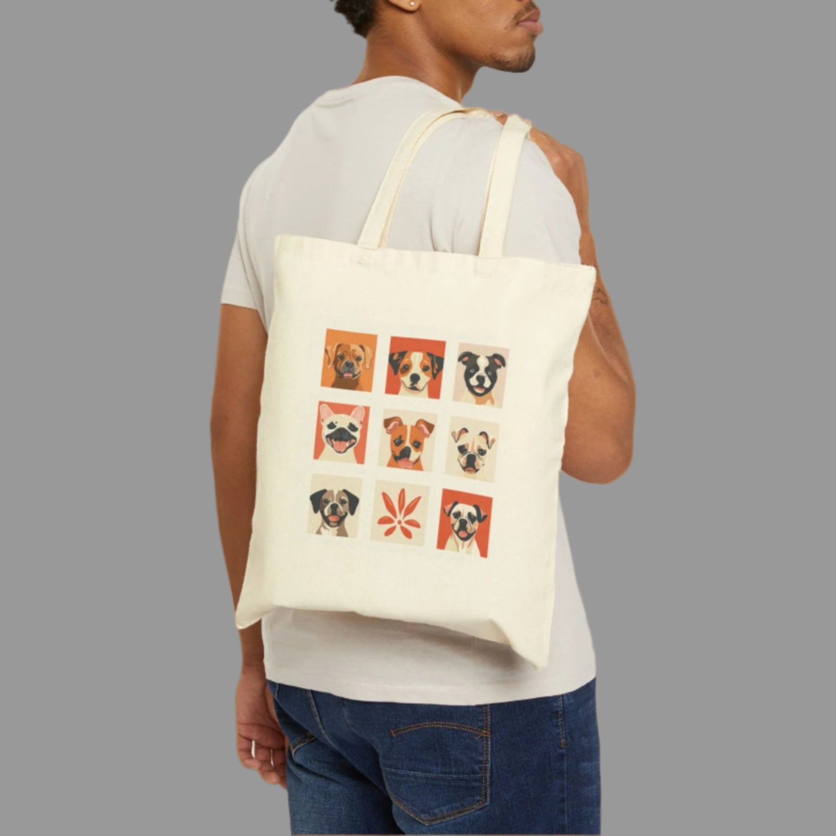 Man carrying a tote bag with dog illustrations on a white background