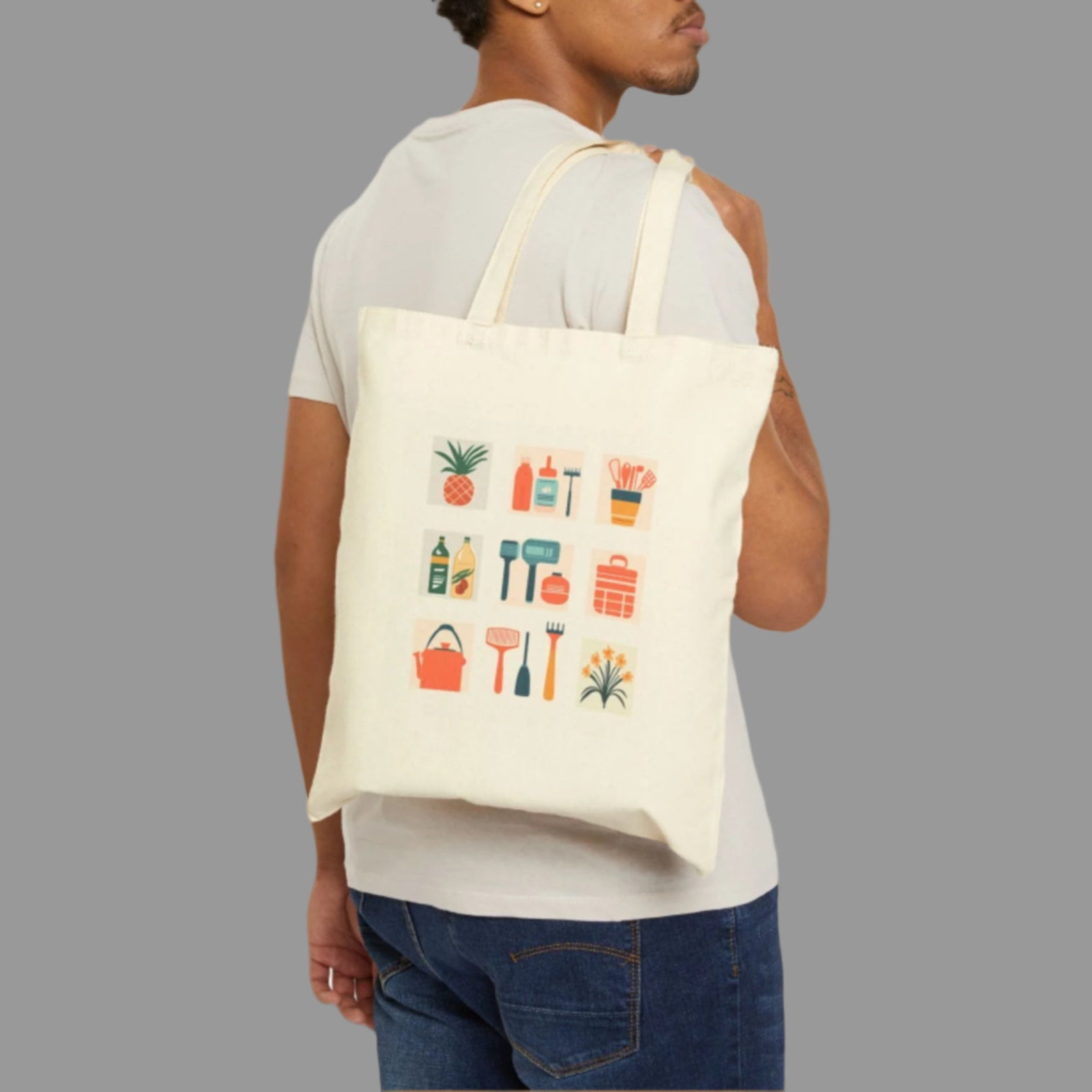 Man carrying a tote bag with colorful graphics on a white background