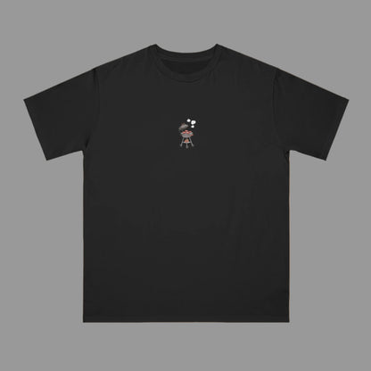Black t-shirt with a small graphic on a beige background