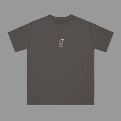 Dark gray t-shirt with a small graphic on a beige background