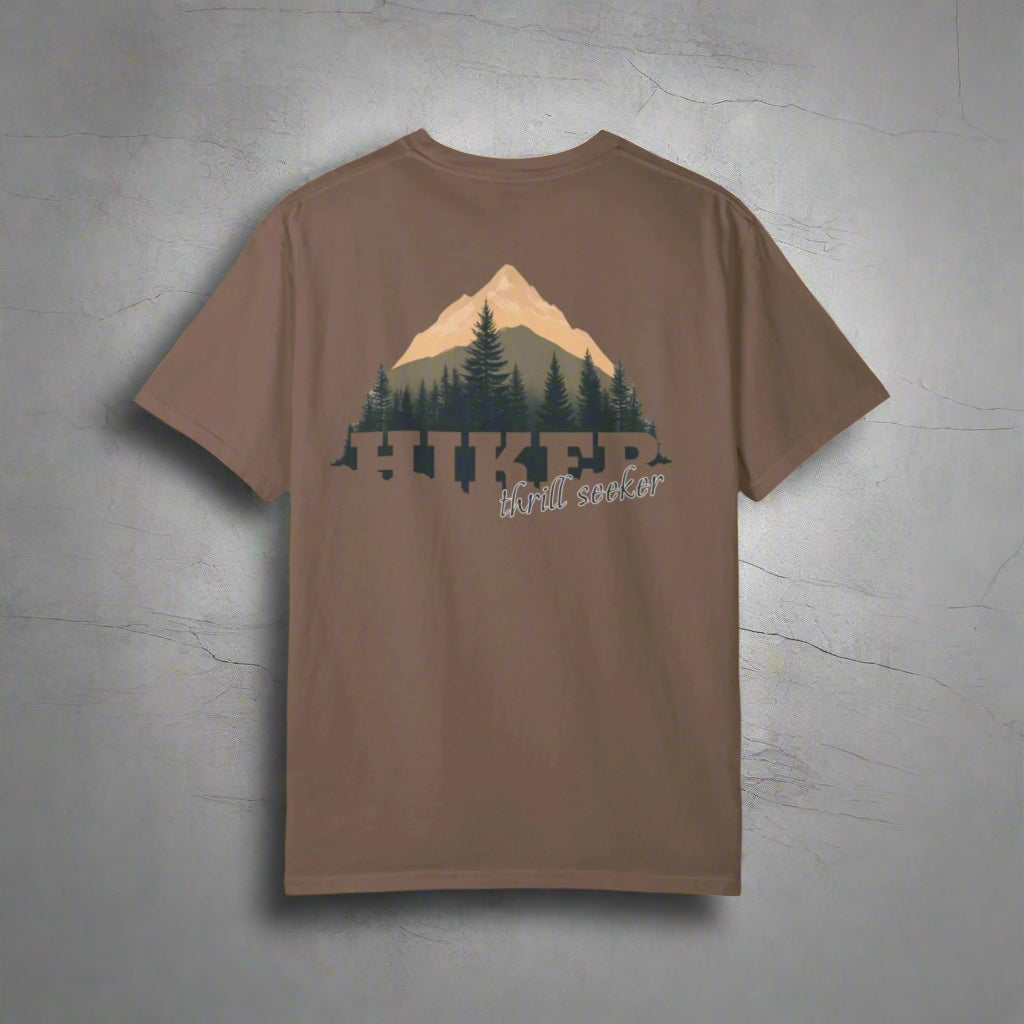 Brown t-shirt with a mountain and tree graphic on the back, on a white background
