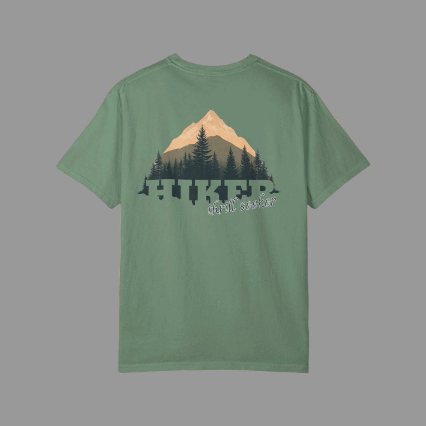 Green t-shirt with mountain and tree design on a white background