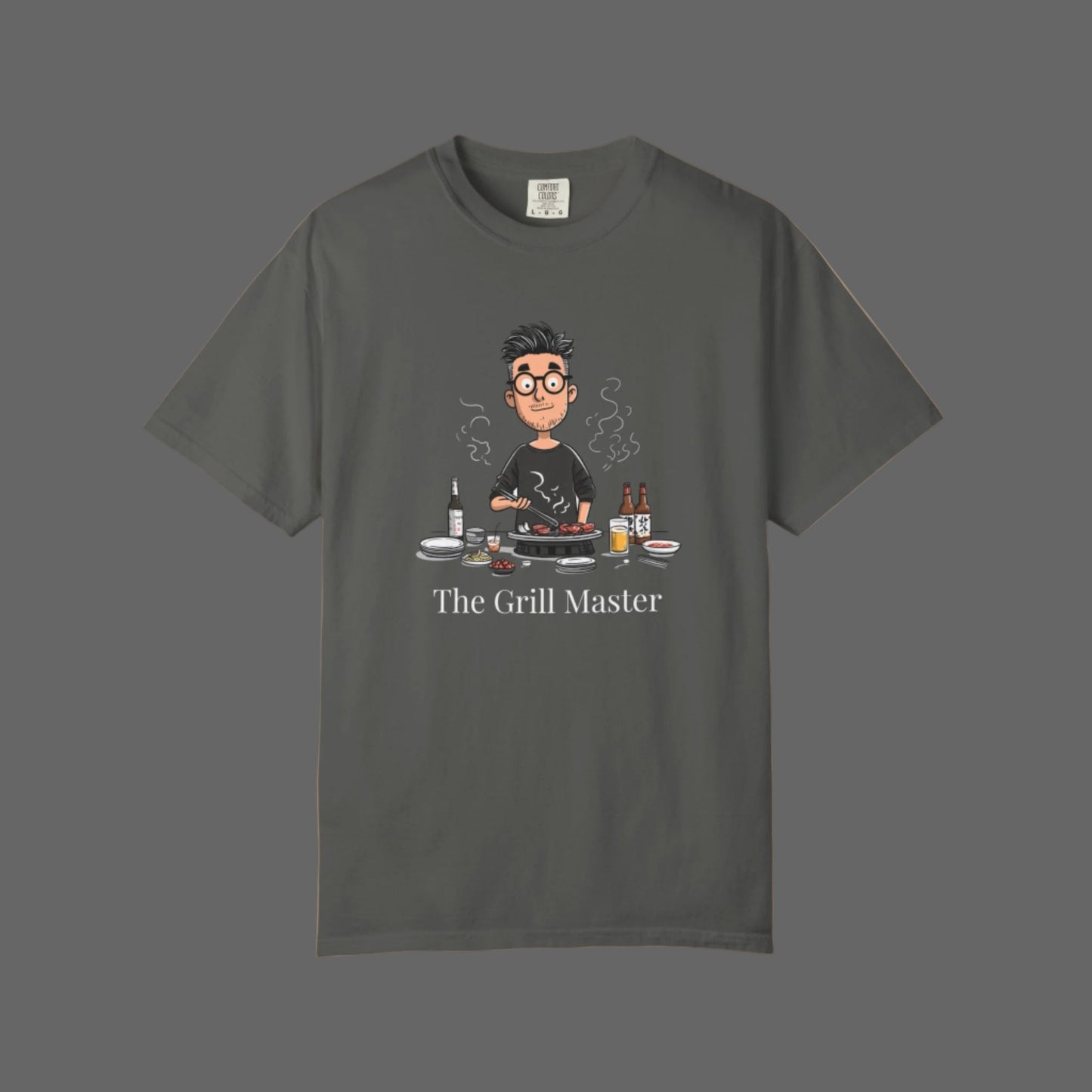 Gray t-shirt with a graphic of a person grilling and the text 'The Grill Master' on a white background.