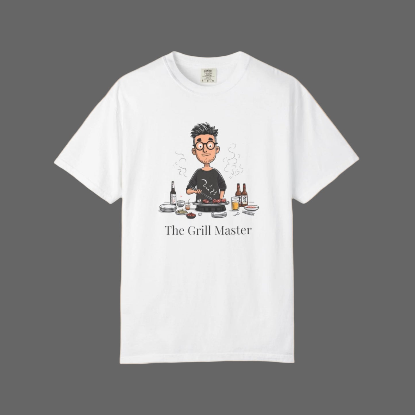 White t-shirt with a graphic of a person cooking and text 'The Grill Master' on a white background