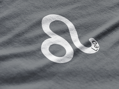 Silver Leo zodiac sign on a textured gray background