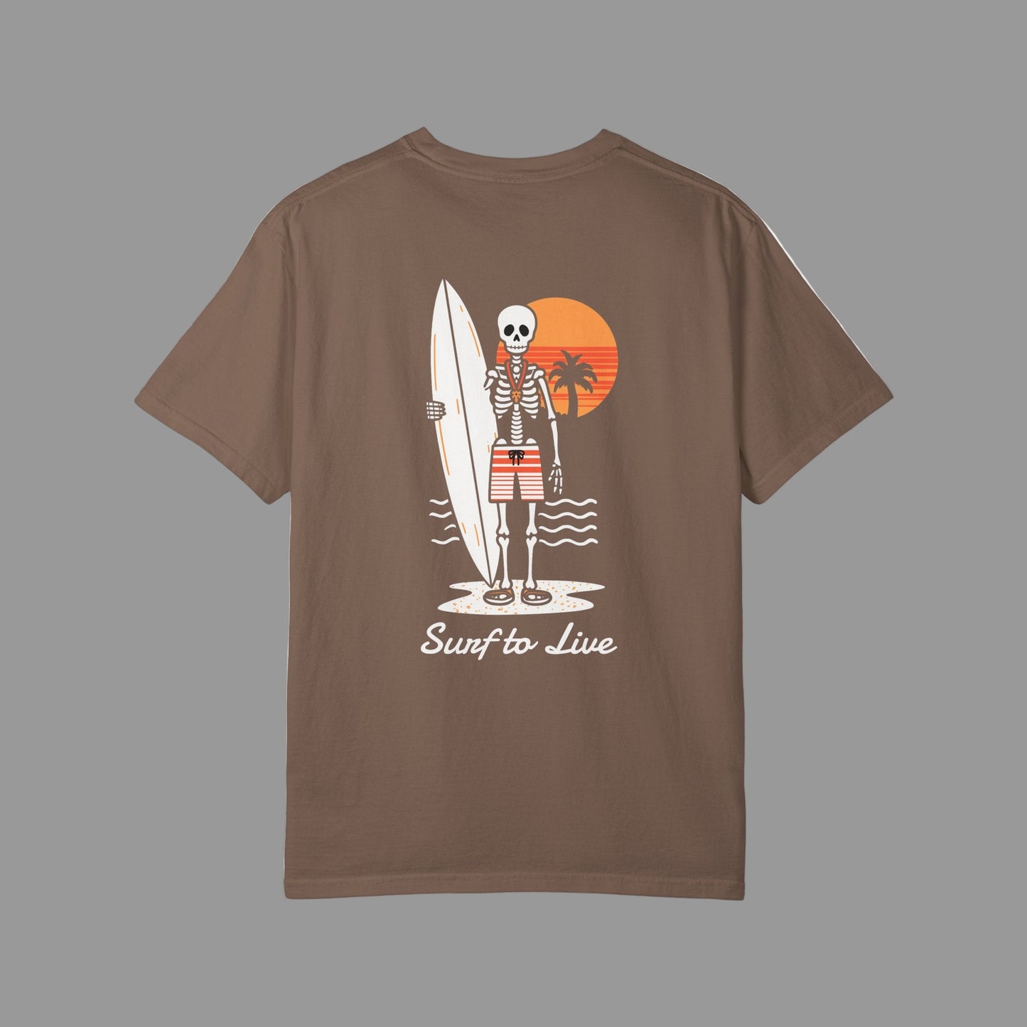 Brown t-shirt with a skeleton holding a surfboard design on the back, set against a white background.