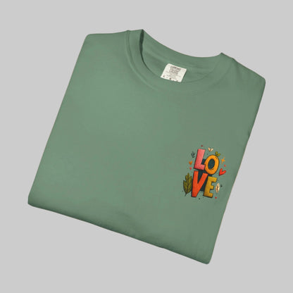 Folded green t-shirt with 'LOVE' design on a white background