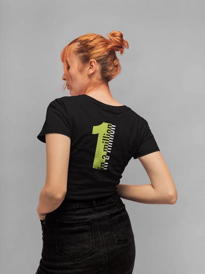 Woman wearing a black t-shirt with a green logo on the back against a gray background