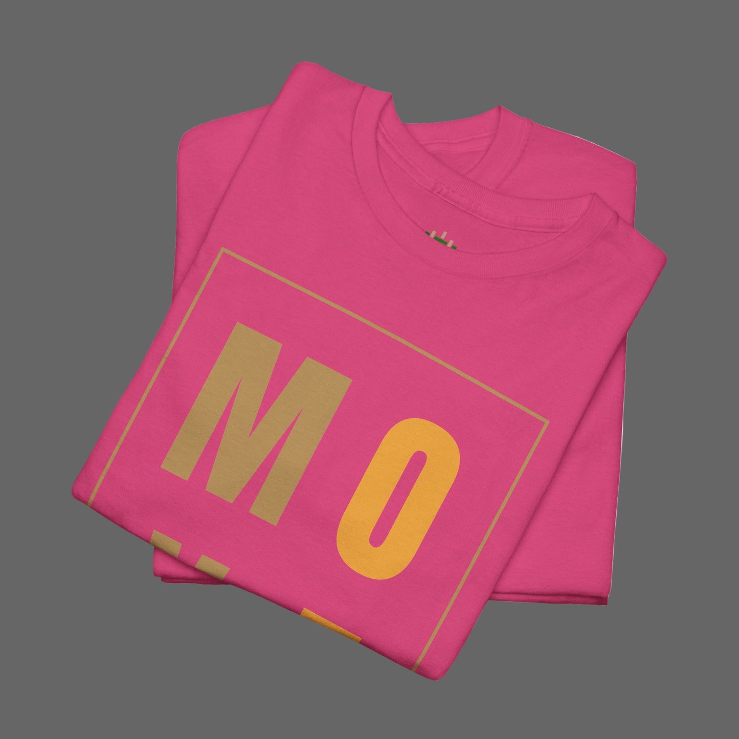 Folded pink t-shirt with 'MO' printed on it against a white background
