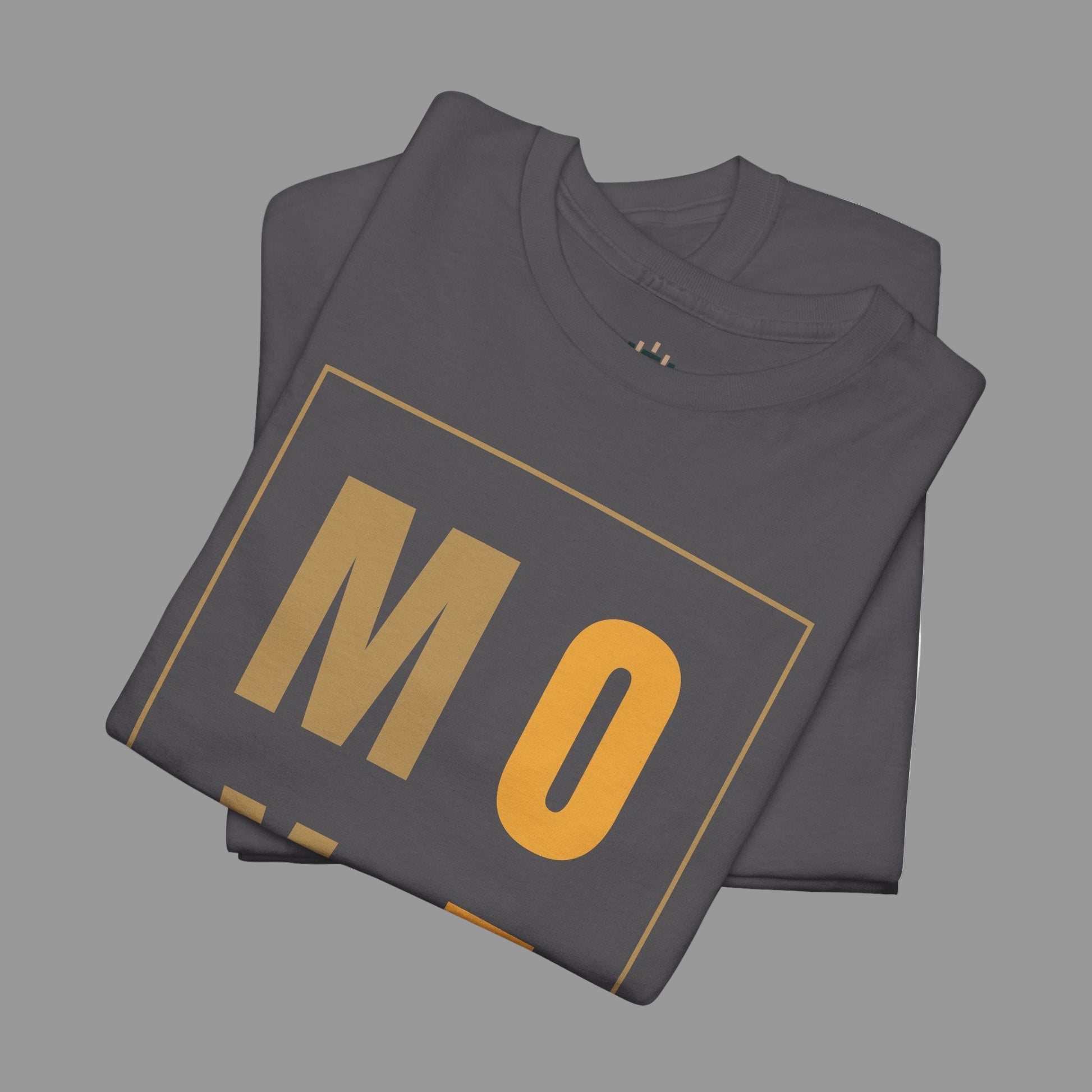 Folded dark gray t-shirt with 'MO' printed in gold on a white background
