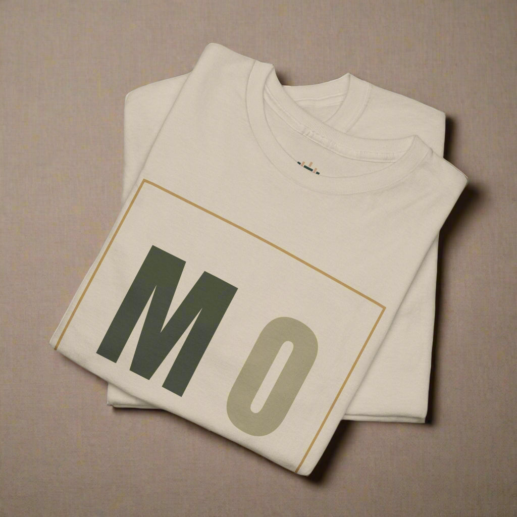 Beige t-shirt with 'MO' printed on it, folded and displayed against a white background