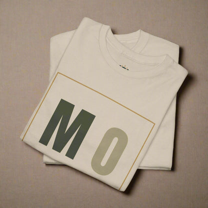 Beige t-shirt with 'MO' printed on it, folded and displayed against a white background