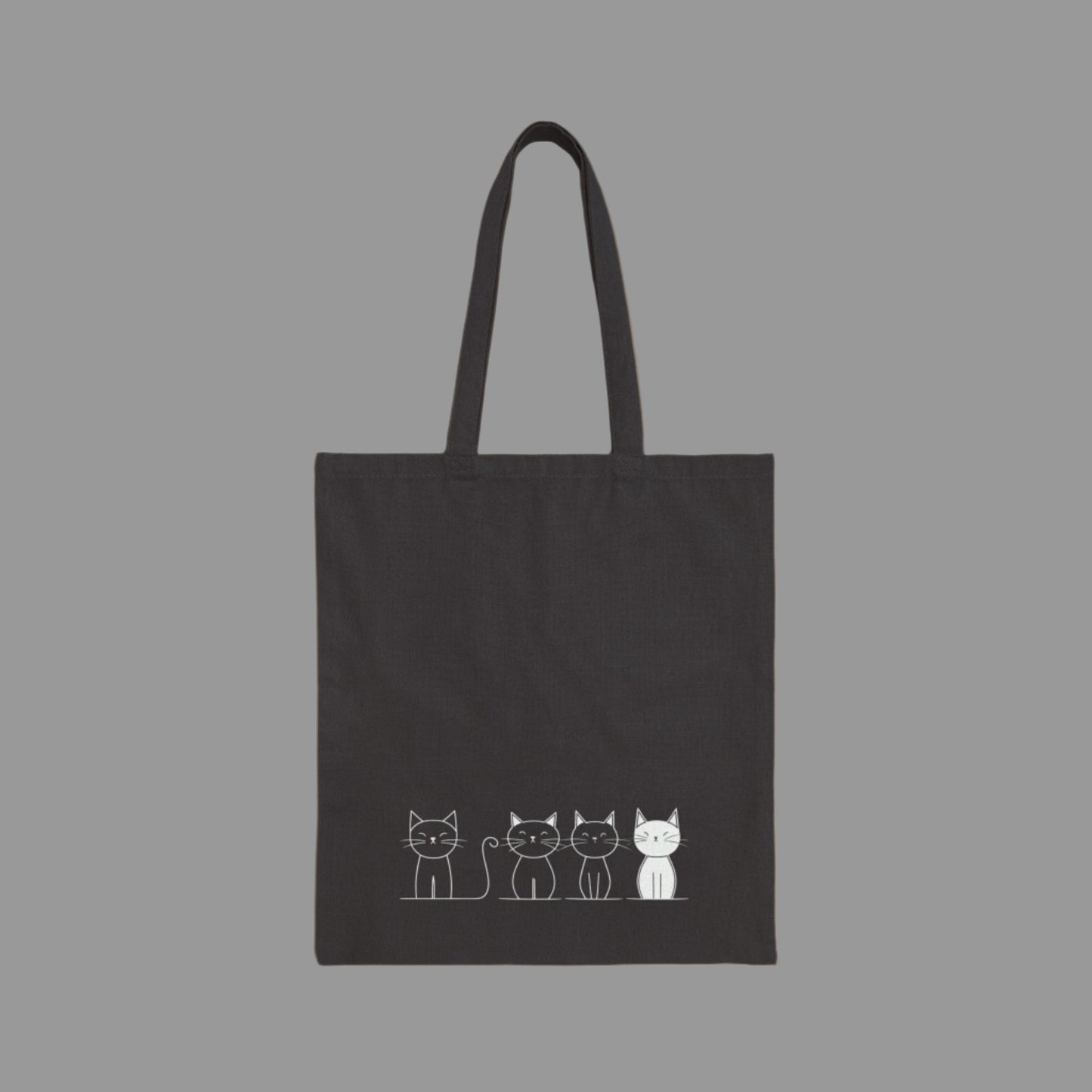 Black tote bag with white cat illustrations on a white background