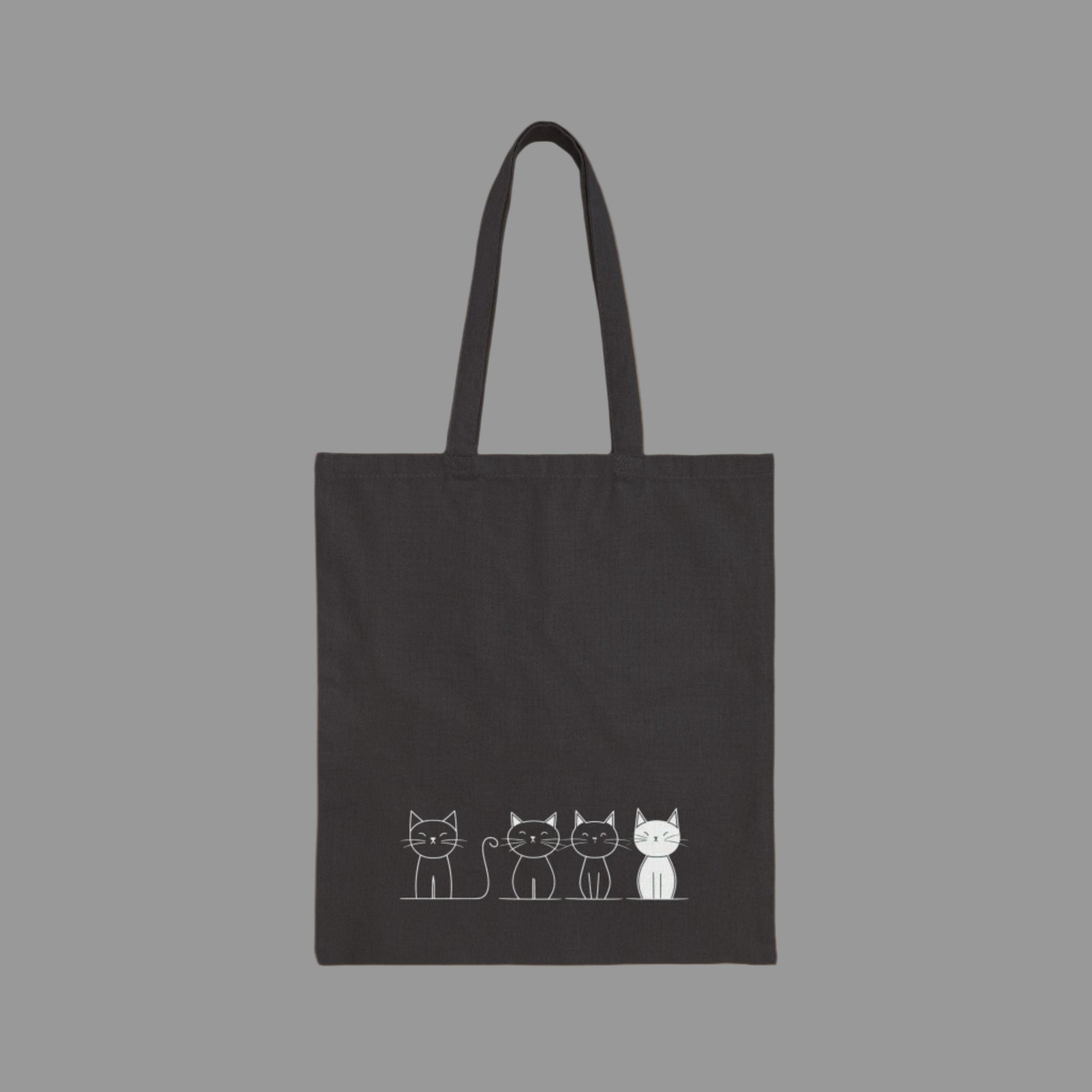 Black tote bag with white cat illustrations on a white background