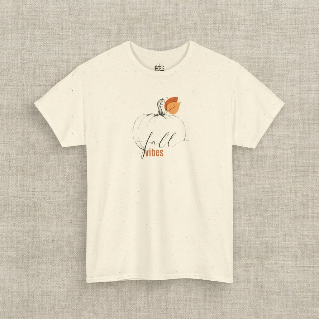 Beige t-shirt with a pumpkin and 'Fall Vibes' text design on a white background