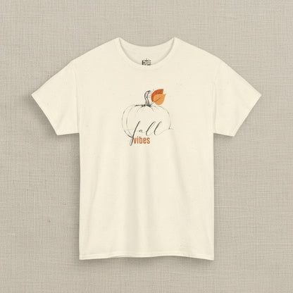 Beige t-shirt with a pumpkin and 'Fall Vibes' text design on a white background