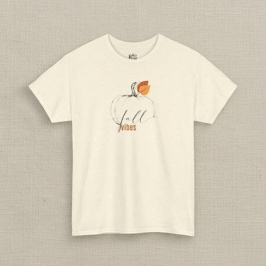 Beige t-shirt with a pumpkin and 'Fall Vibes' text design on a white background