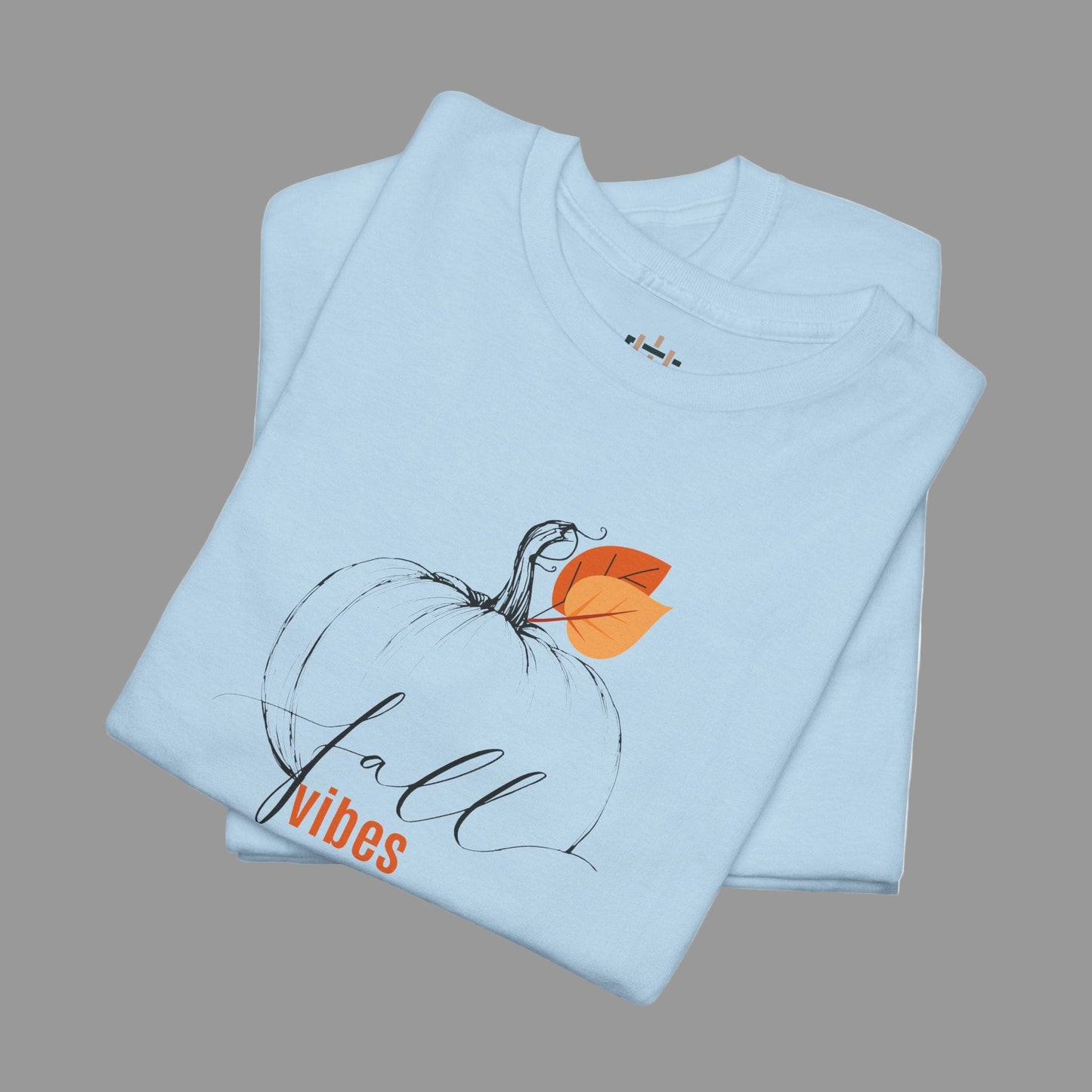 Light blue t-shirt with a pumpkin design and 'fall vibes' text on a white background