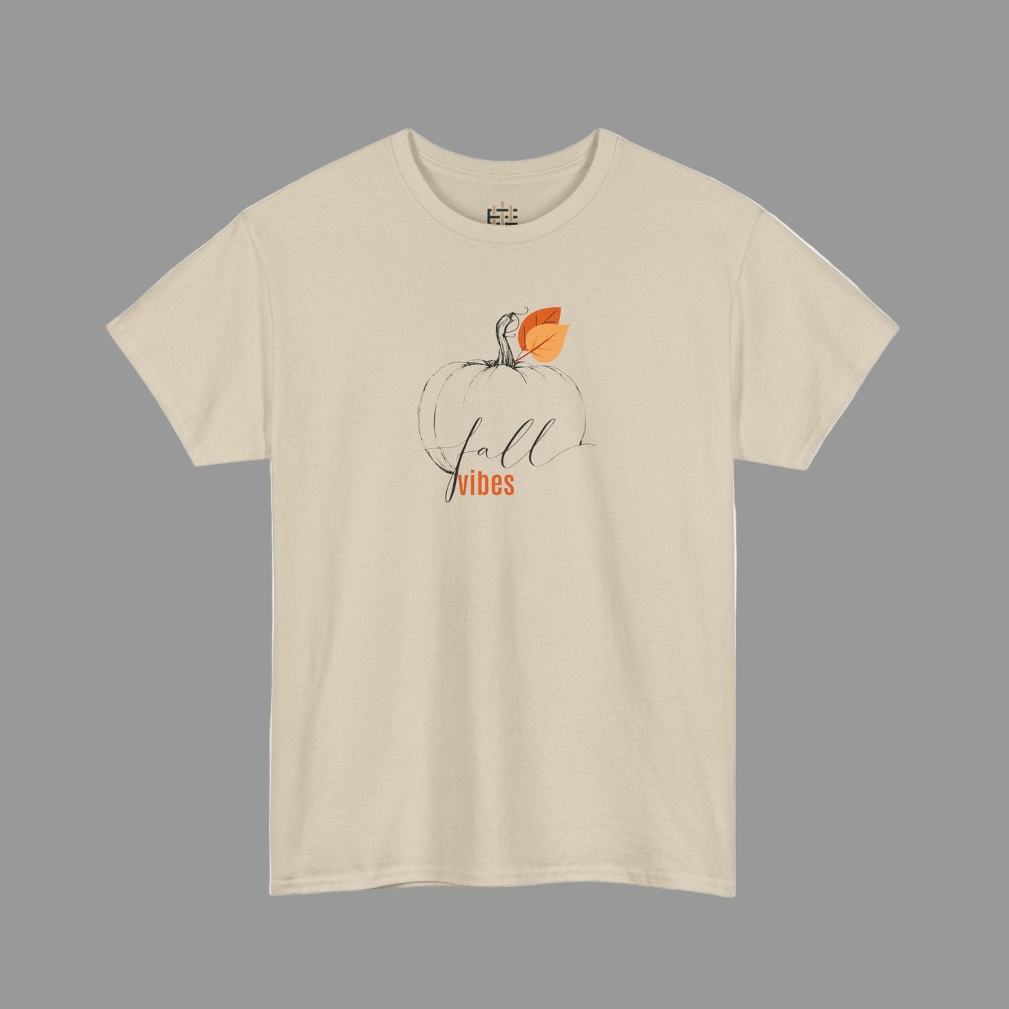 Beige t-shirt with a pumpkin graphic and 'fall vibes' text on a white background