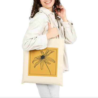 Woman holding a tote bag with a floral design on a white background