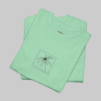 Folded light green t-shirt with a small graphic on a white background