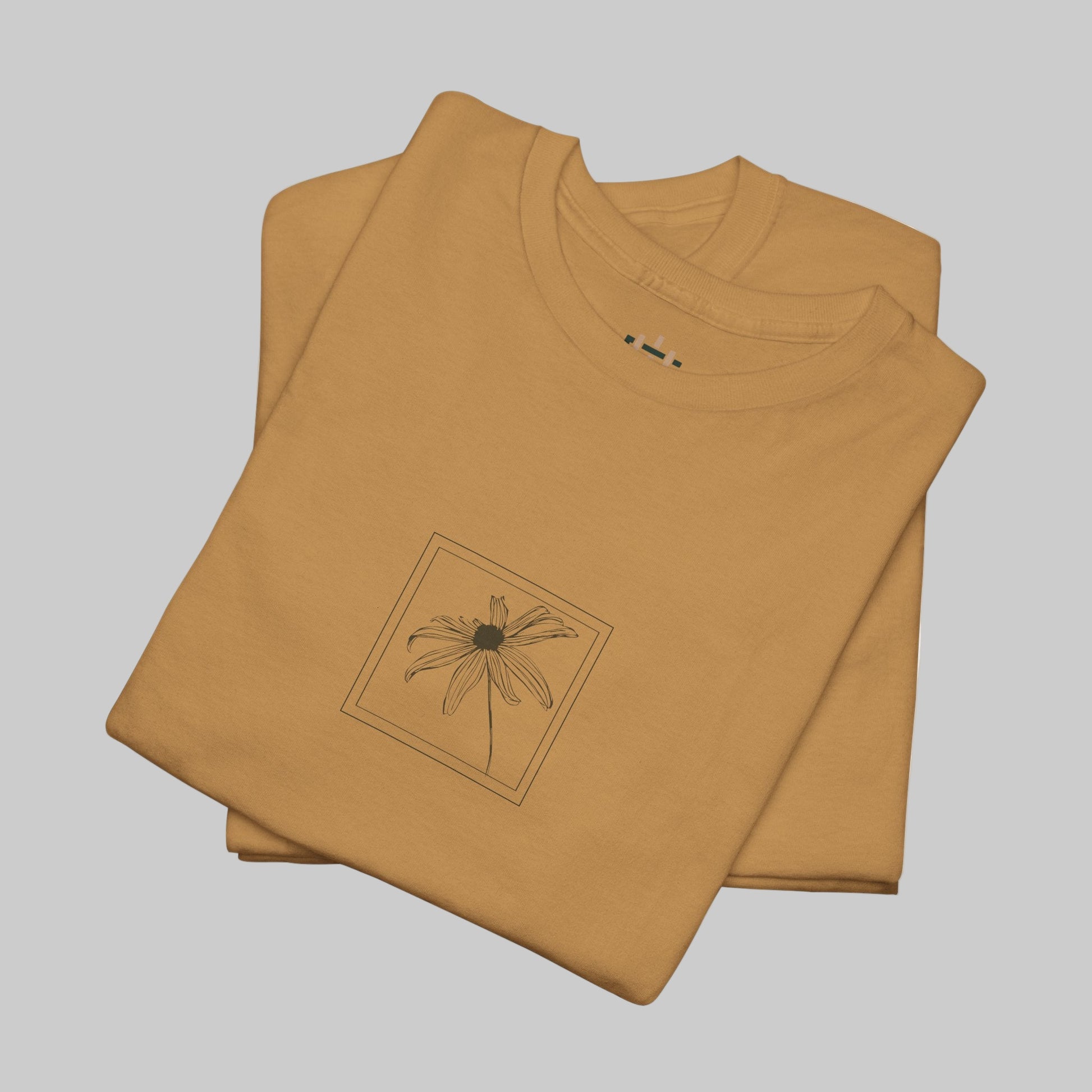 Folded brown t-shirt with a black floral design on a white background