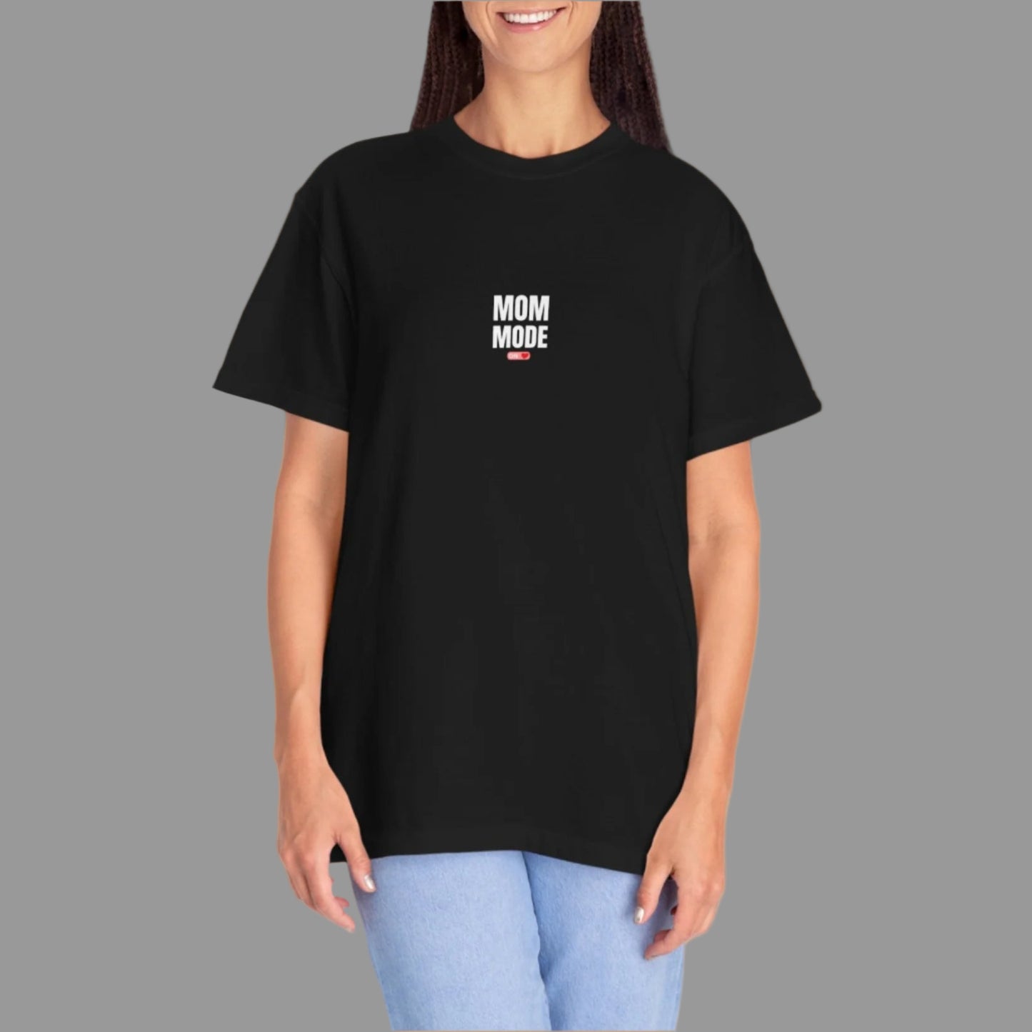 Person wearing a black t-shirt with 'Mom Mode' text on a white background