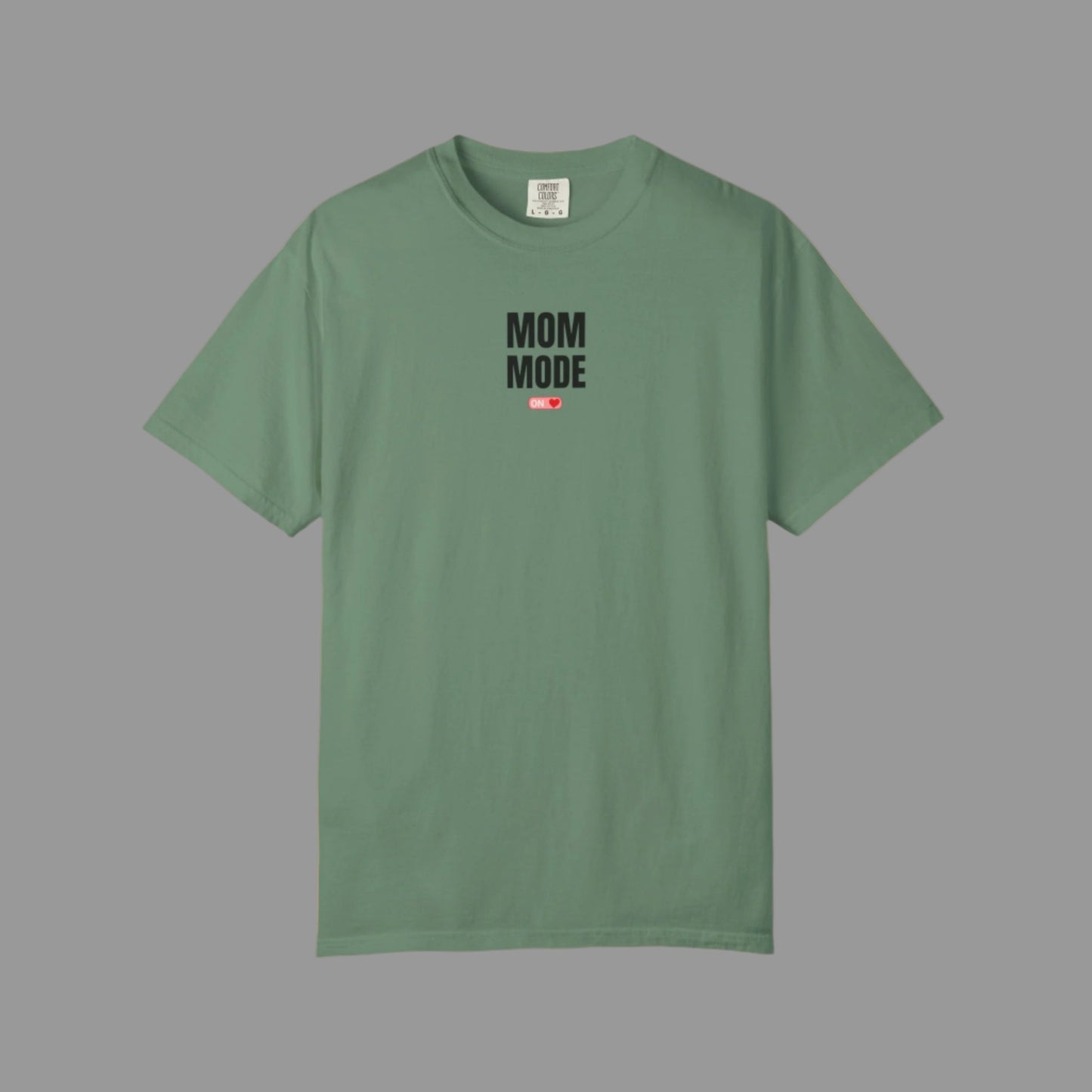 Green t-shirt with 'Mom Mode' text on a white background