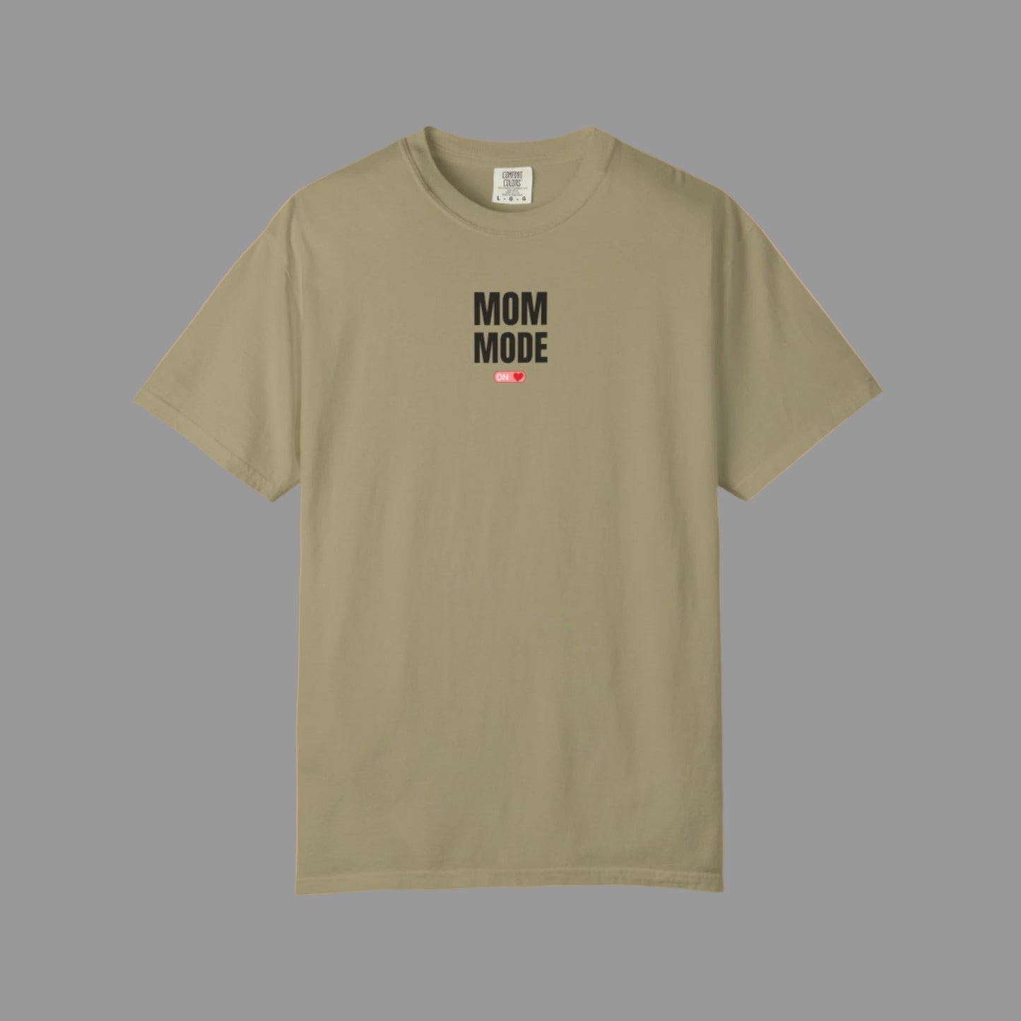 Beige t-shirt with 'Mom Mode' text on a white background