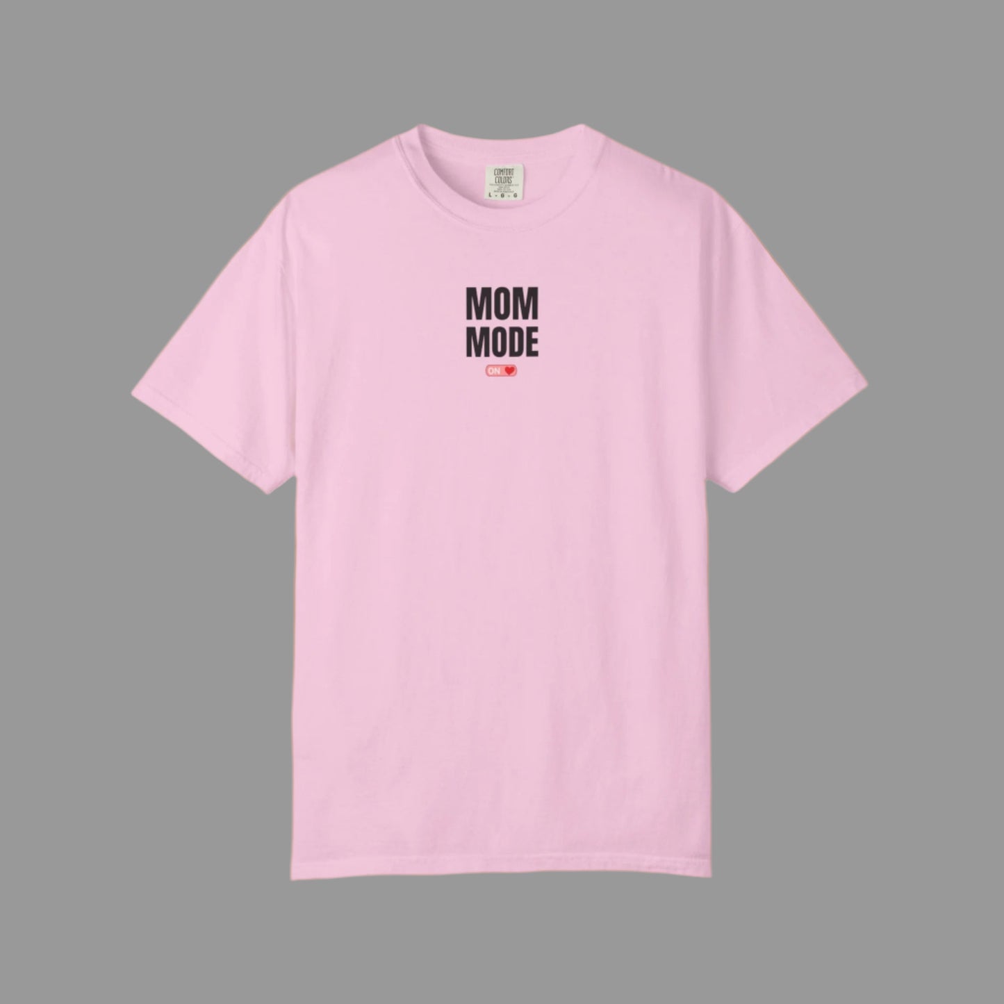 Pink t-shirt with 'Mom Mode' text on a white background
