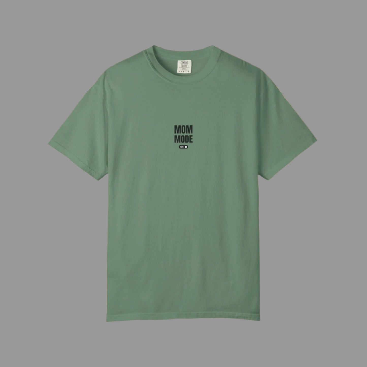 Green t-shirt with 'MOM MODE' text on a white background