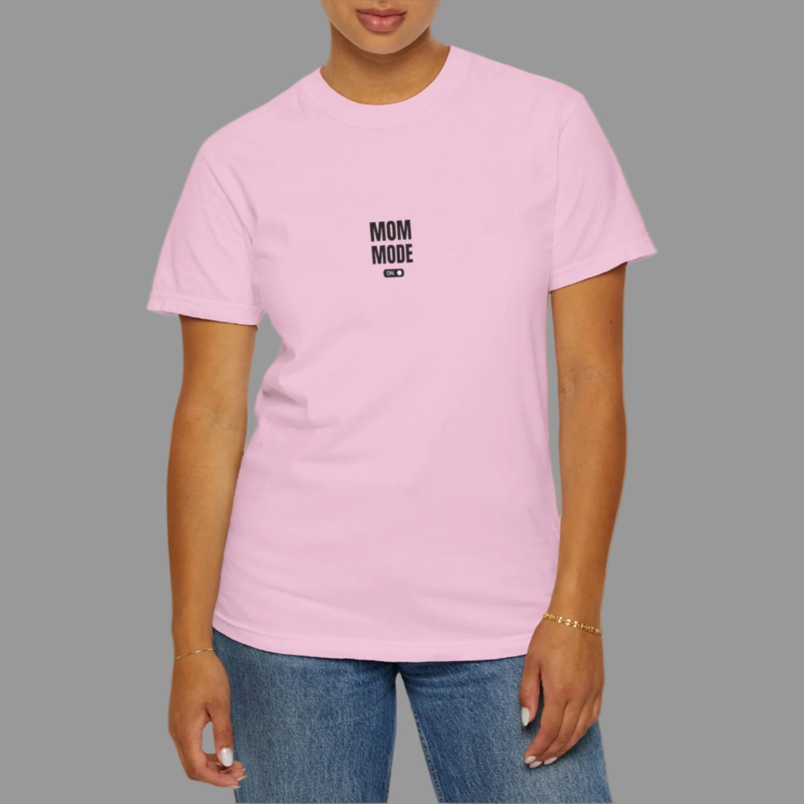 Person wearing a pink t-shirt with text on a white background
