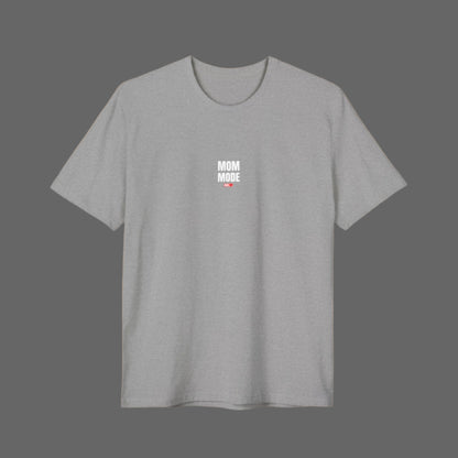 A woman wearing a black crew neck t-shirt with the text 'MOM MODE' on the front.