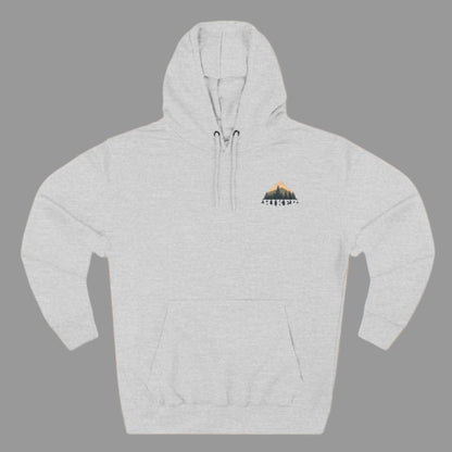 A person wearing a white fleece hoodie with a hood, featuring a small embroidery design on the chest.