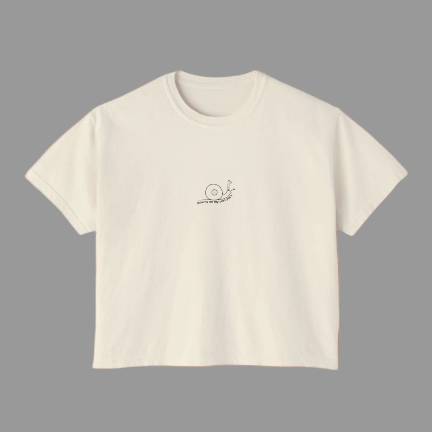 Beige t-shirt with a small logo on a white background