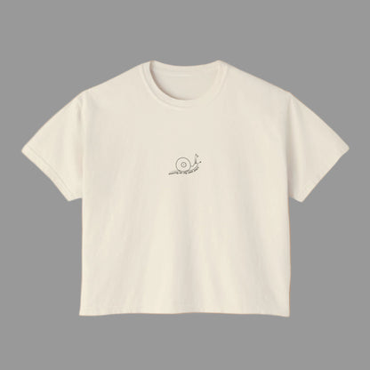 Beige t-shirt with a small logo on a white background