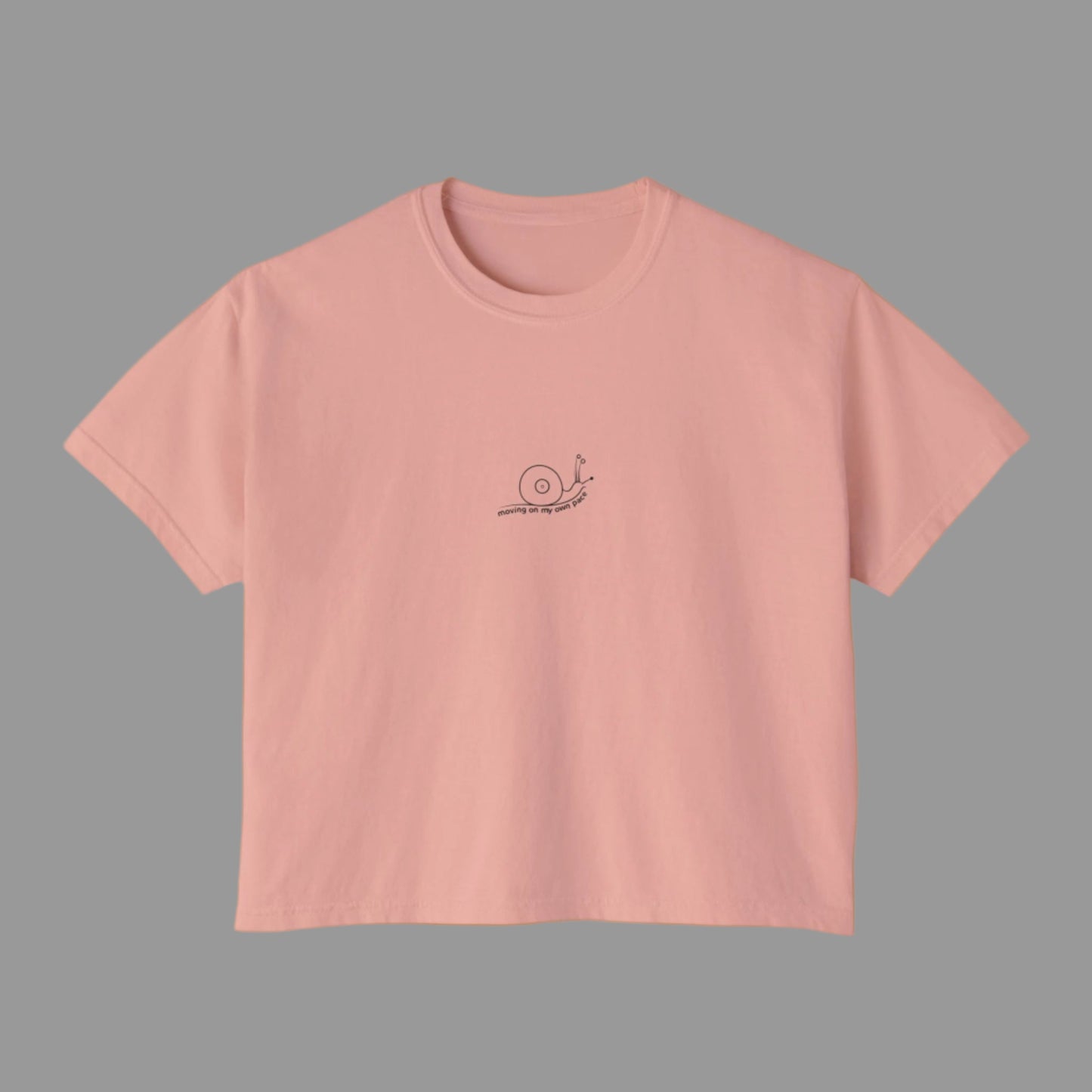 Pink t-shirt with a small logo on a white background