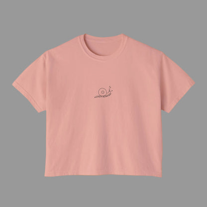 Pink t-shirt with a small logo on a white background