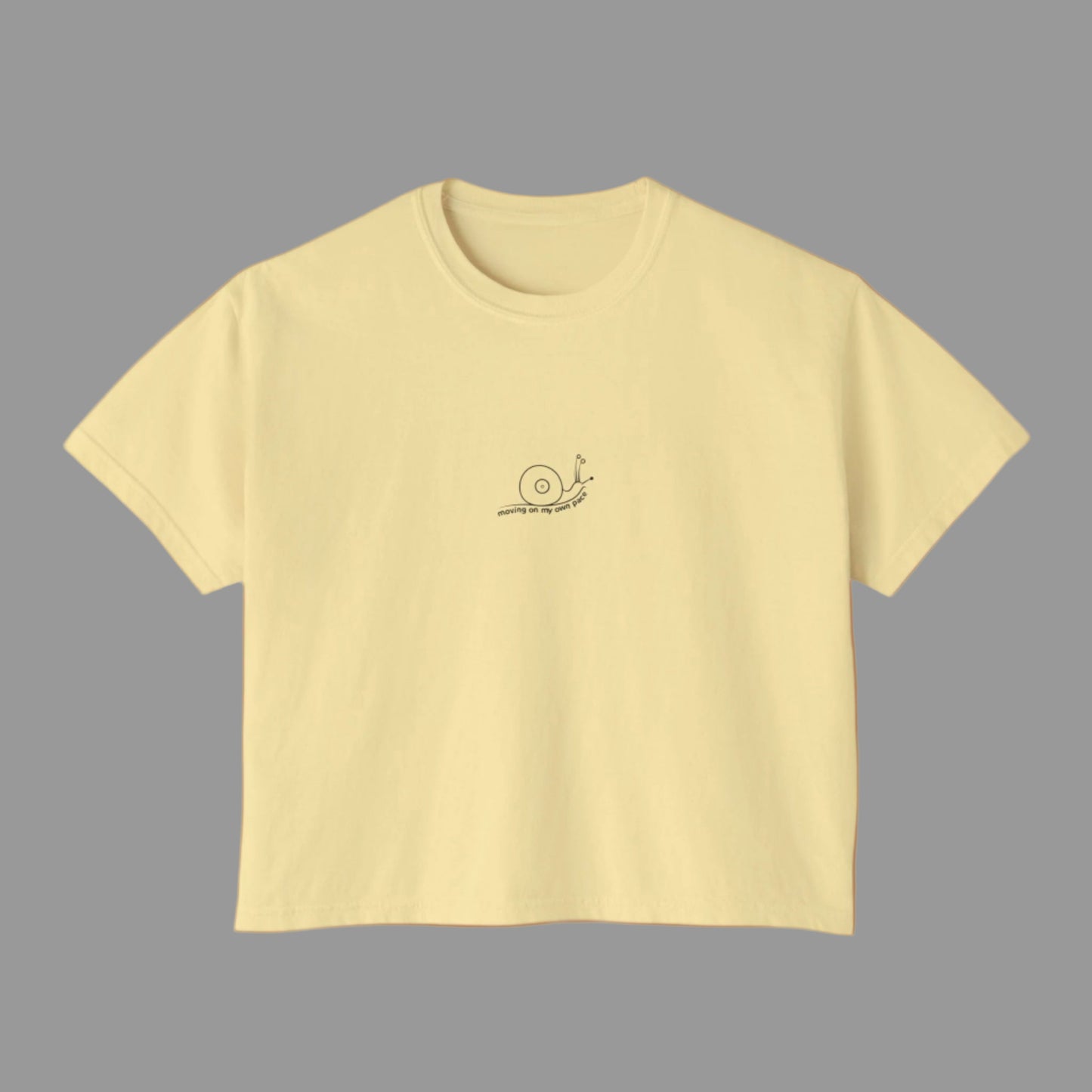 Yellow t-shirt with a small logo on a white background