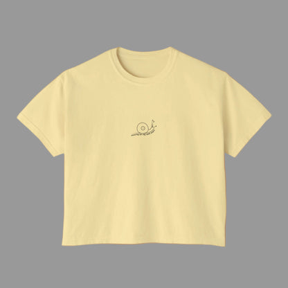 Yellow t-shirt with a small logo on a white background