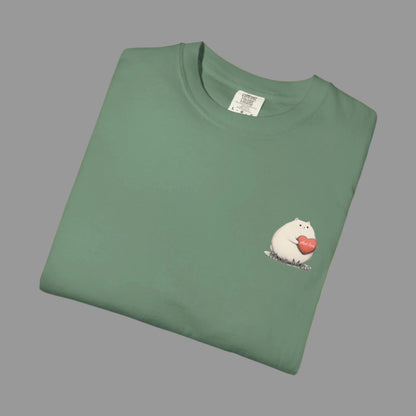 Folded green t-shirt with a small graphic on a white background