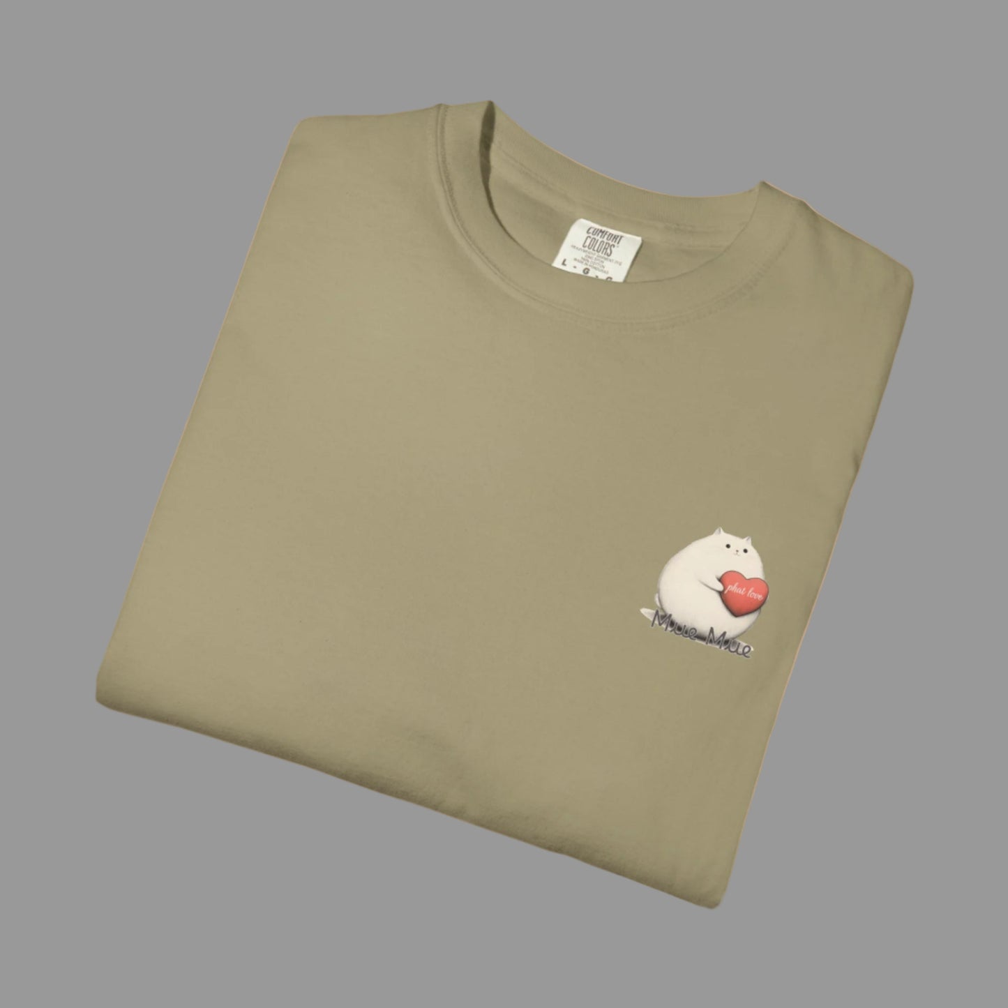 Folded khaki t-shirt with a graphic of a cat holding a heart on a white background