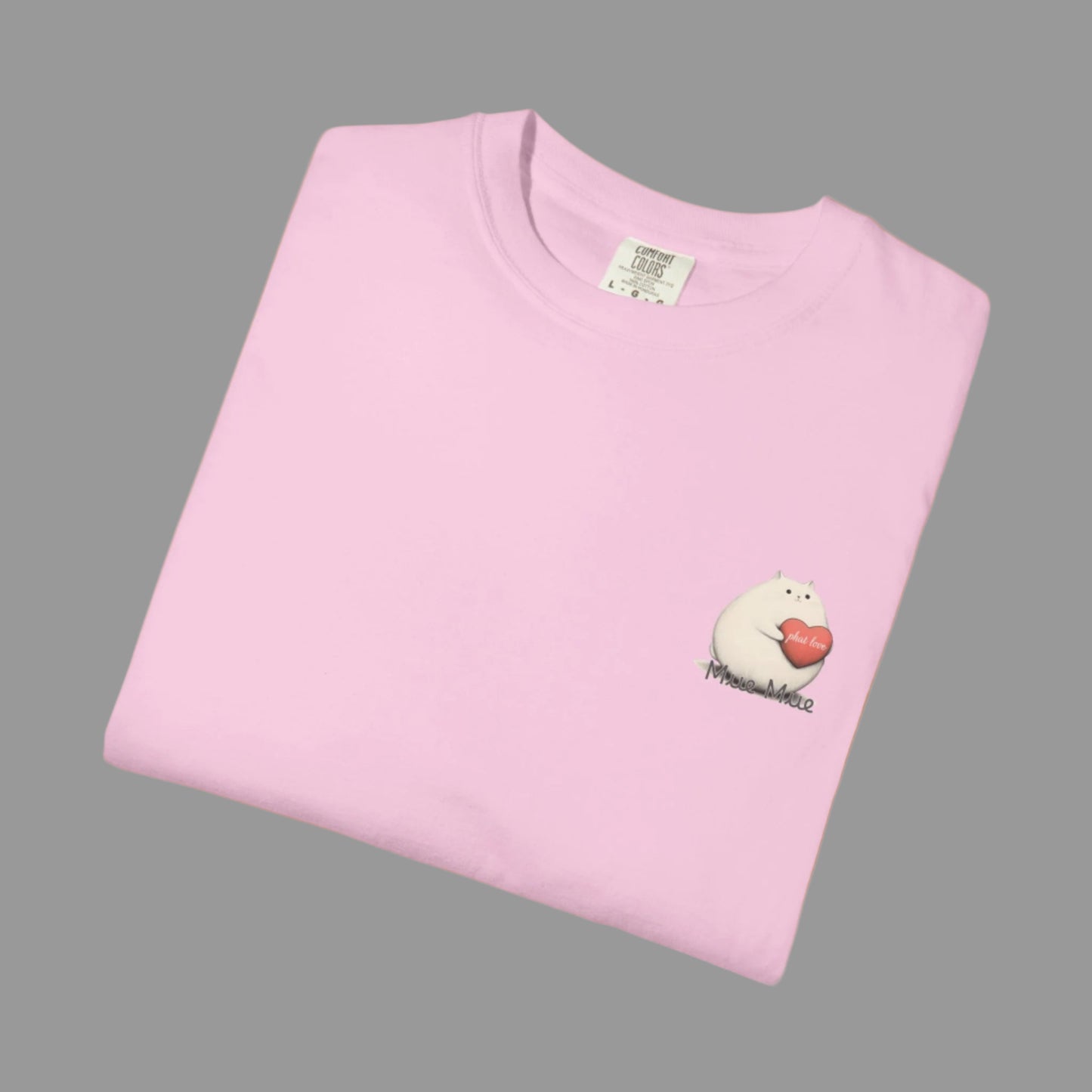 Folded pink t-shirt with a small graphic on a white background